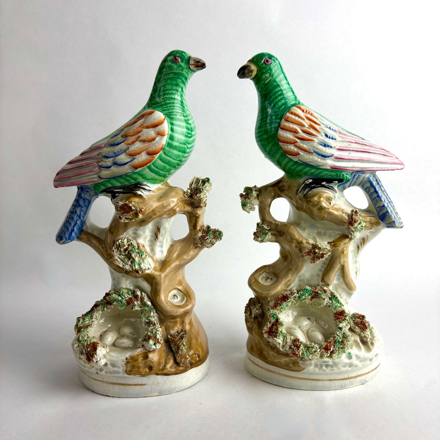 Pair of Antique Staffordshire pottery figurines of exotic pigeons with nests
