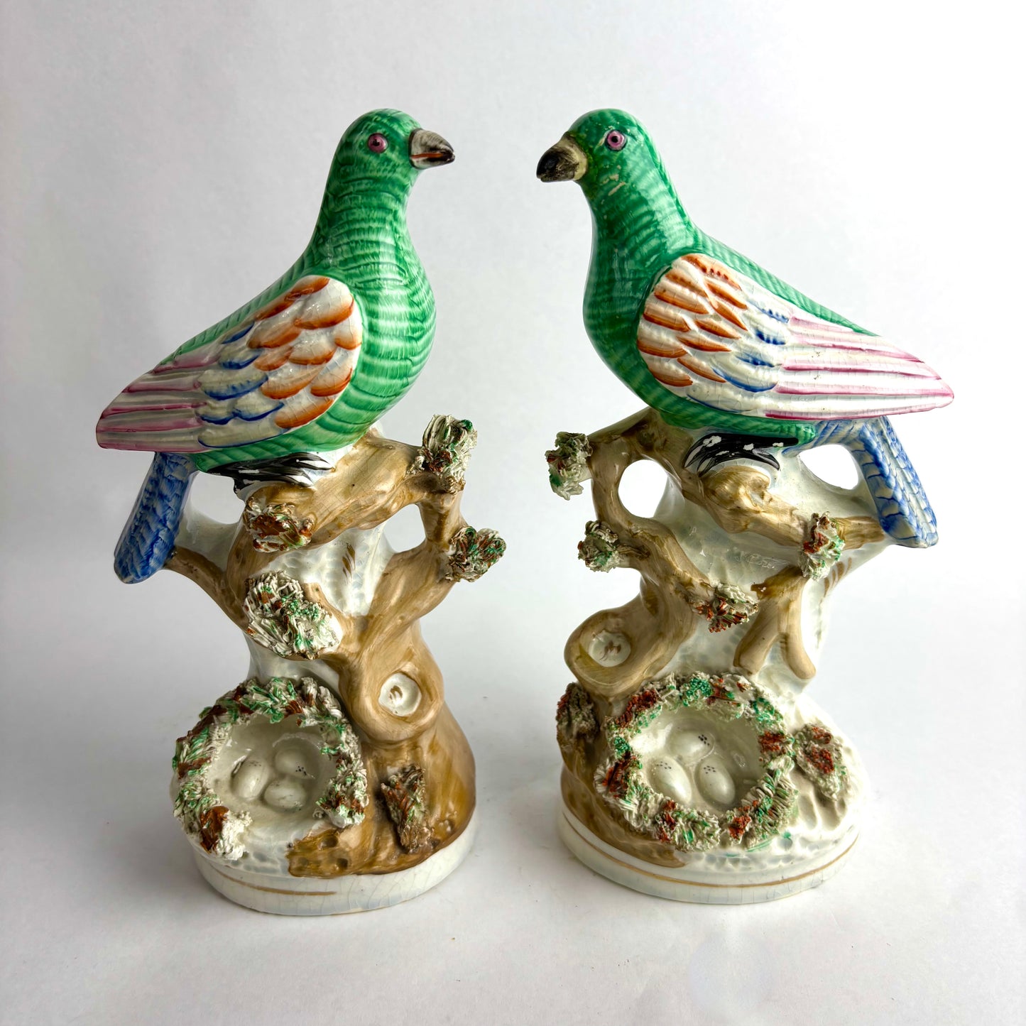 Pair of Antique Staffordshire pottery figurines of exotic pigeons with nests