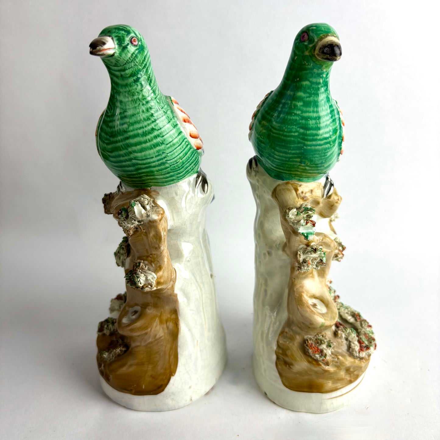Pair of Antique Staffordshire pottery figurines of exotic pigeons with nests