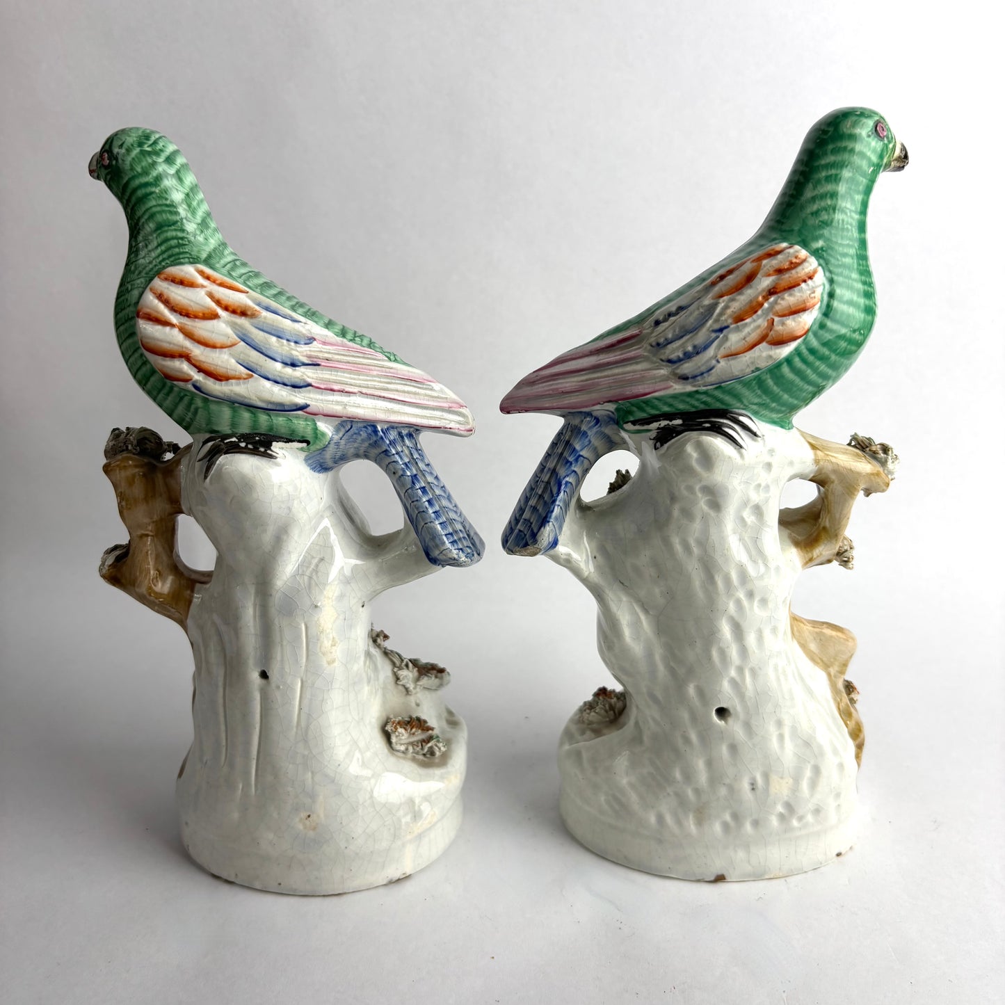Pair of Antique Staffordshire pottery figurines of exotic pigeons with nests