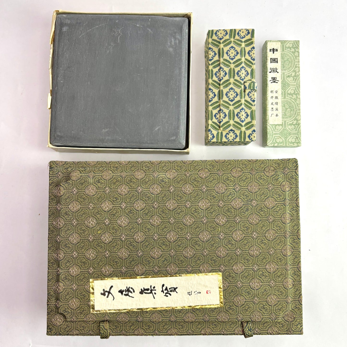 Set of traditional Chinese books and a stone on a white background