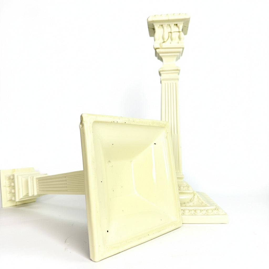 Decorative white pedestal stand with intricate design on a gray background