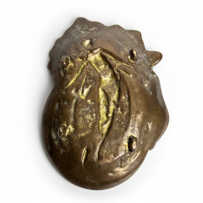 Bronze decorative object with intricate design on a white background