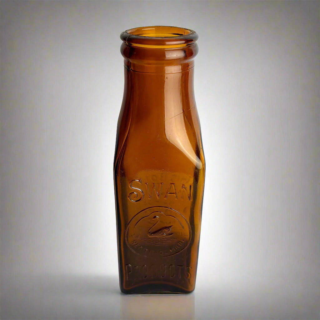 Brown glass bottle with 'Swan' branding on a white background