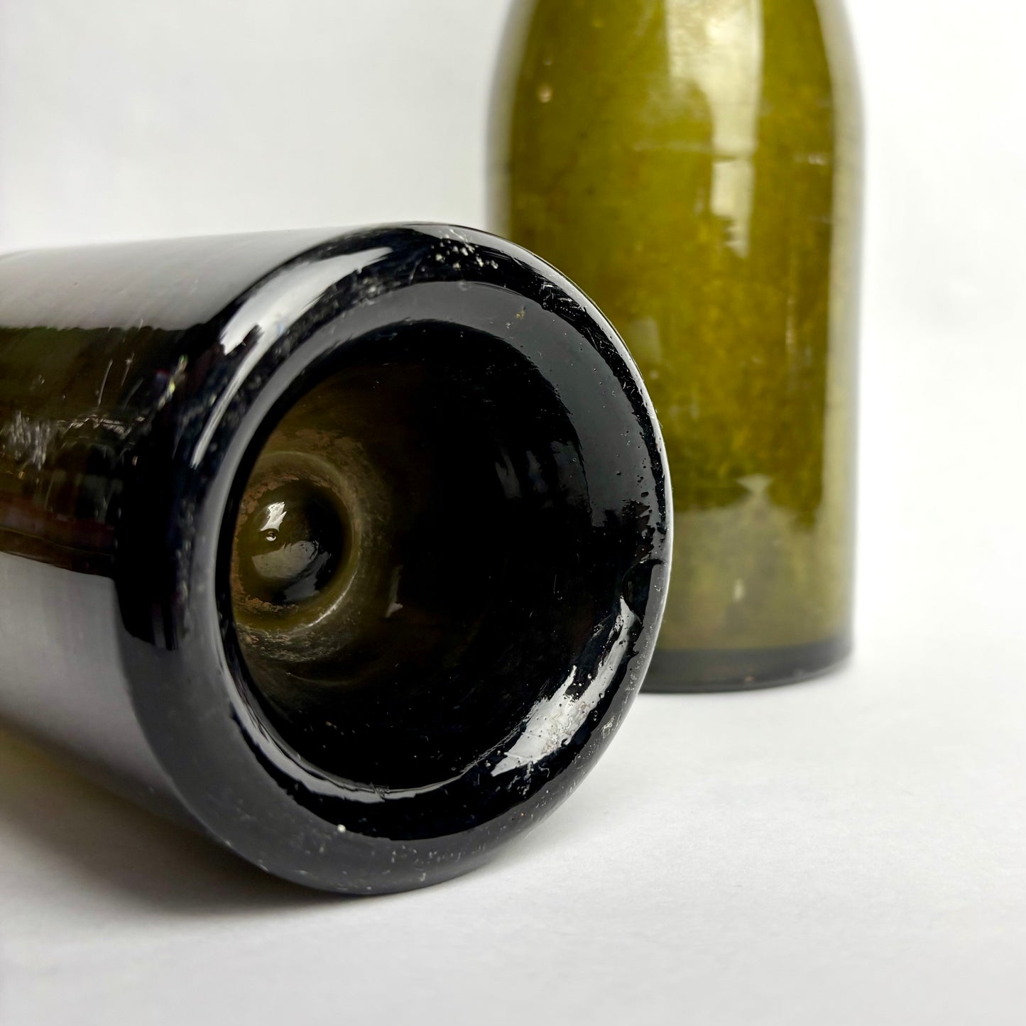 Close-up of a black ceramic bottle cap on a white background