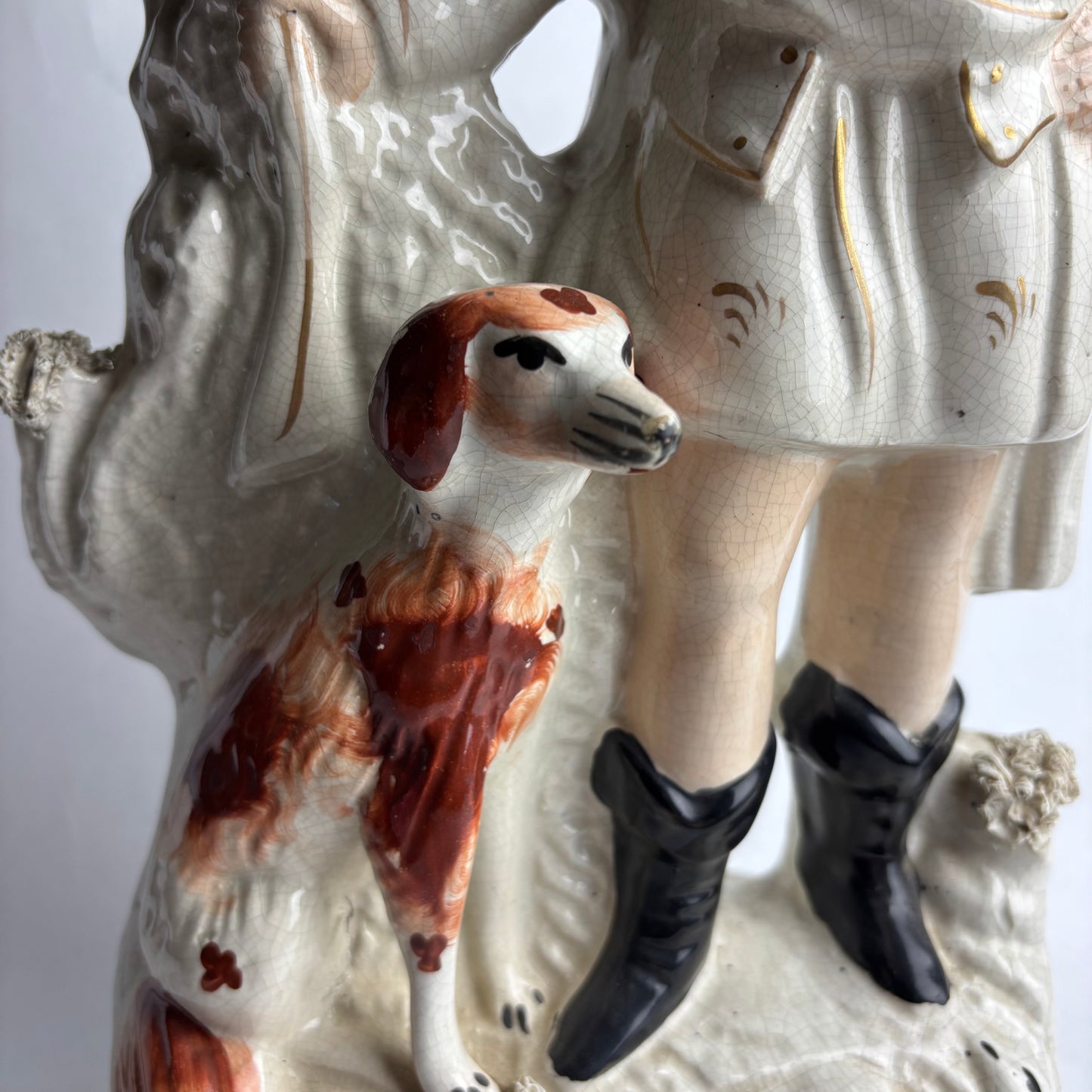 Decorative ceramic figure with a dog and person on a white background