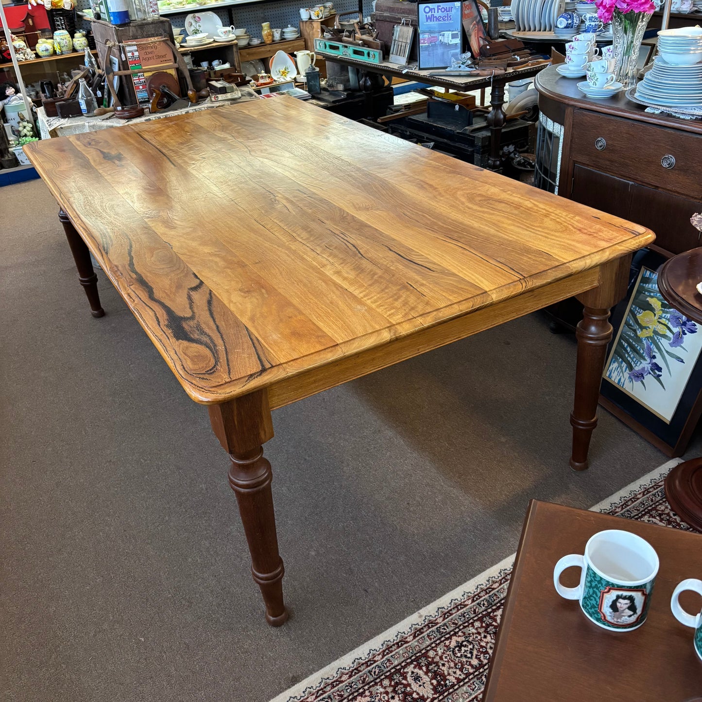 Wooden table in a store setting with various items in the background