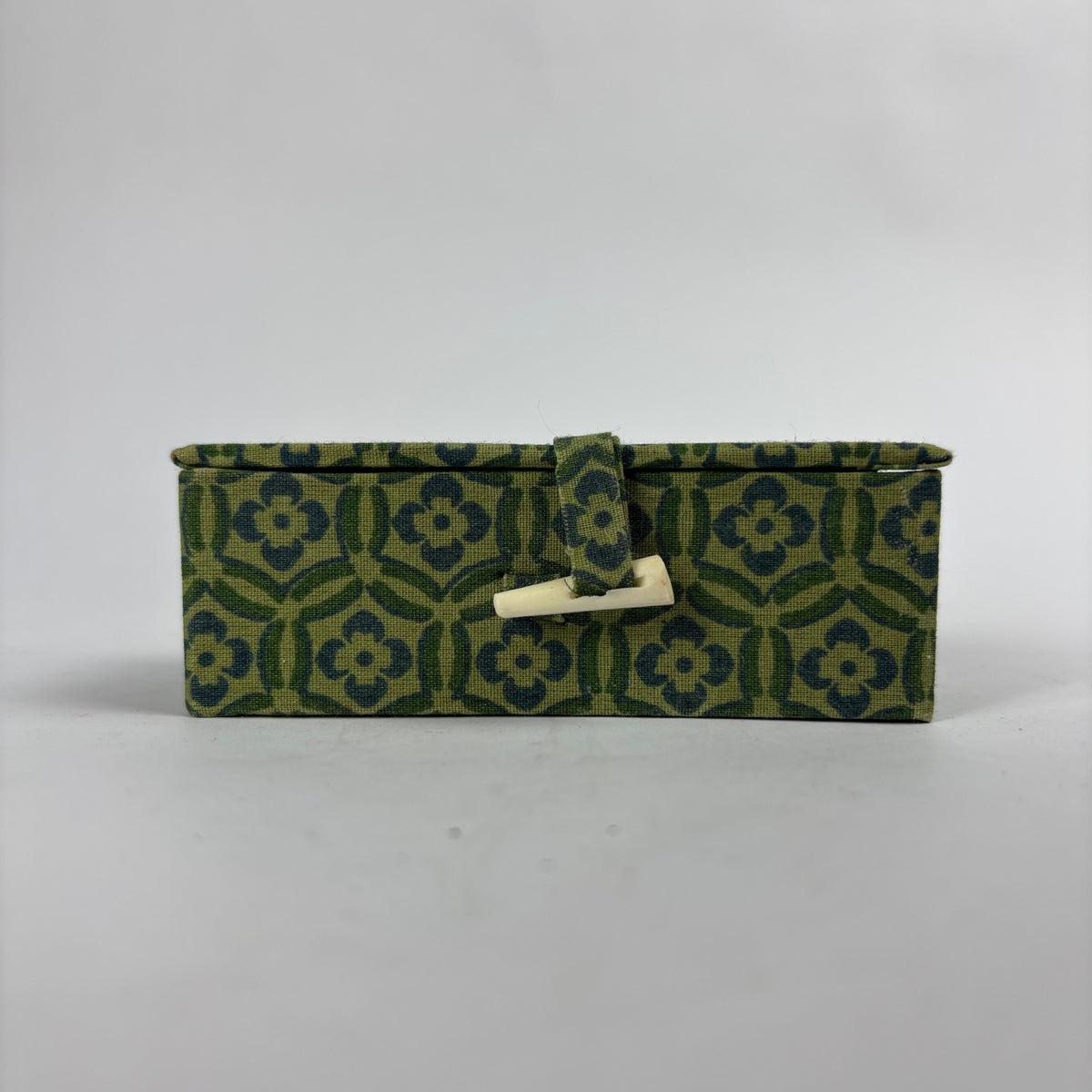 Closed green patterned presentation box
