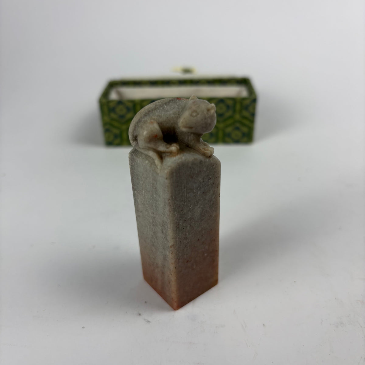 Seal fitted in green brocade case