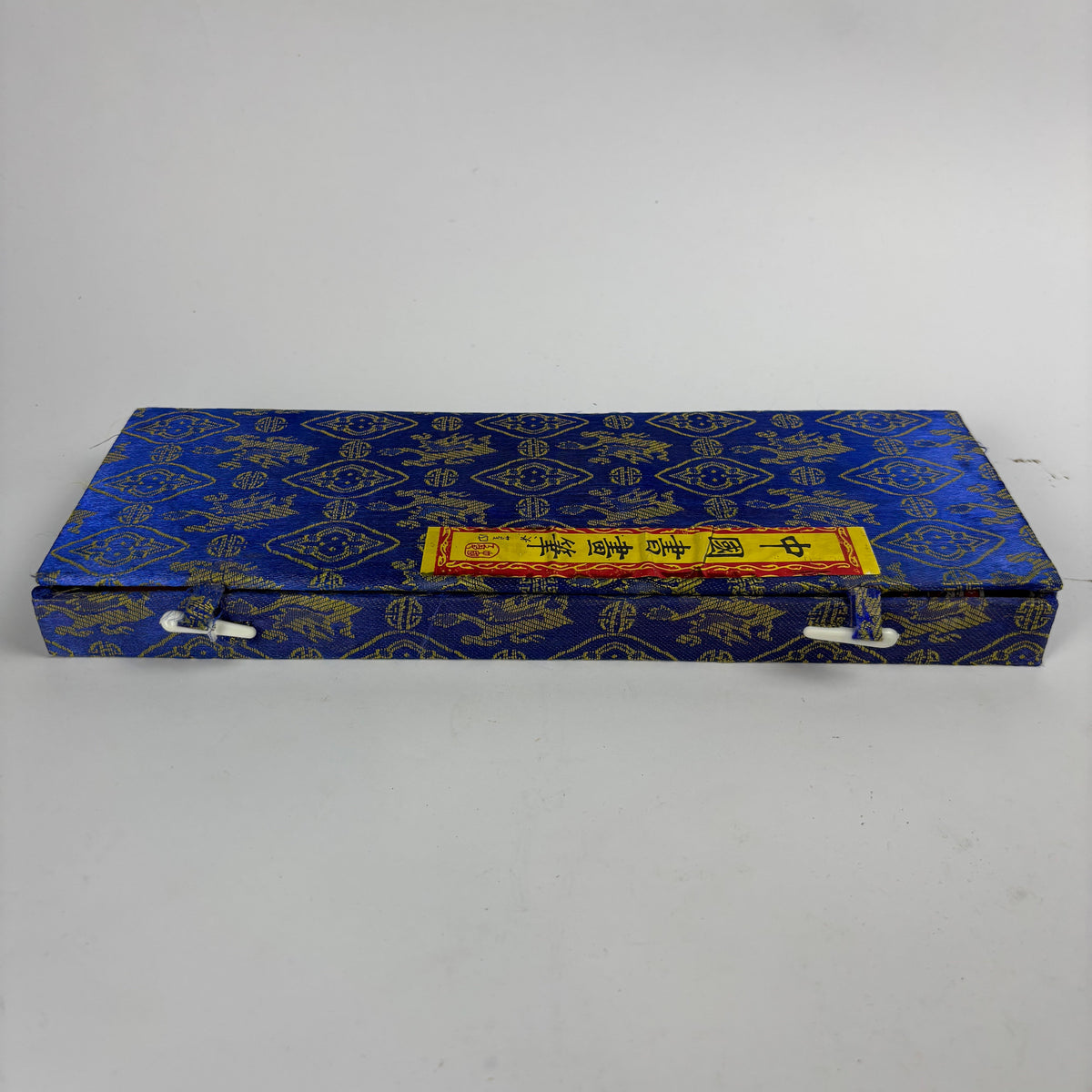 Seven Chinese calligraphy brushes in blue gold brocade case view 1