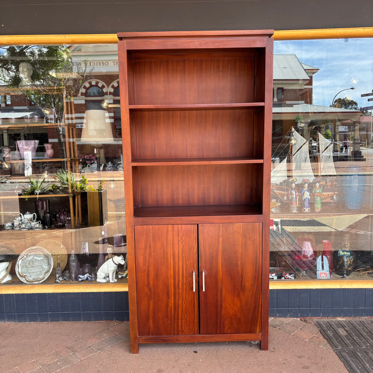 CH Colección Hogar dark wood finish bookcase with two-door cupboard, front view