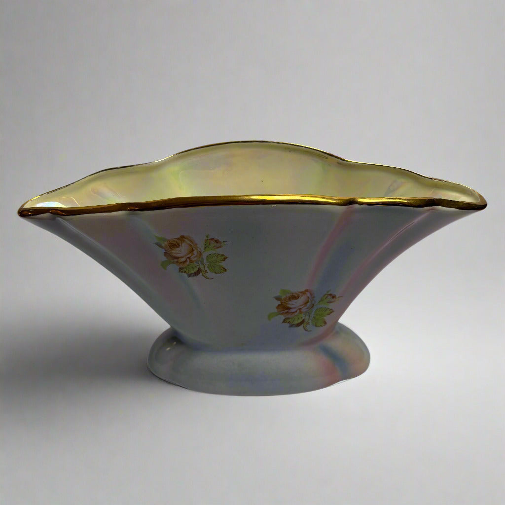 Decorative ceramic bowl with floral patterns and gold rim on a white background
