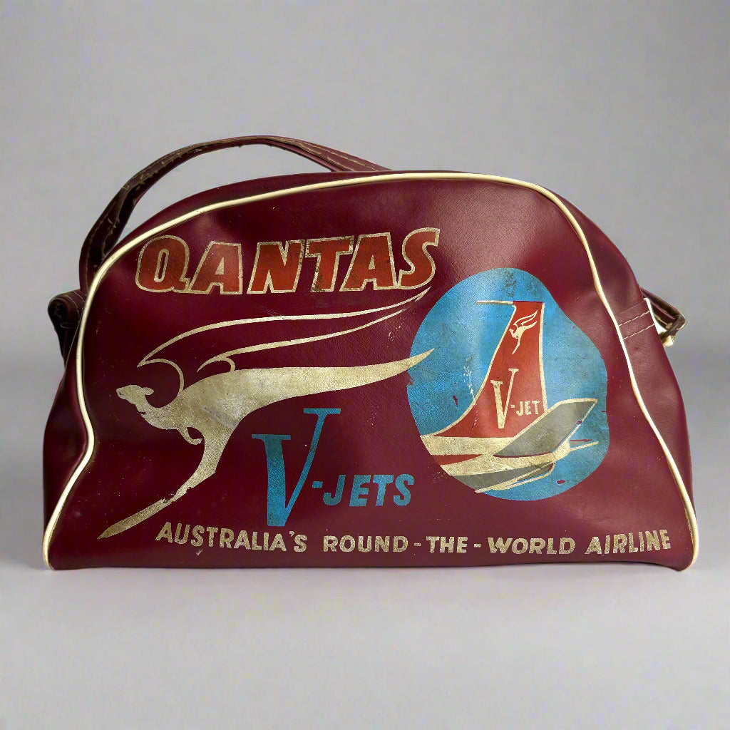 Vintage Qantas travel bag with kangaroo logo and airplane illustration on a white background