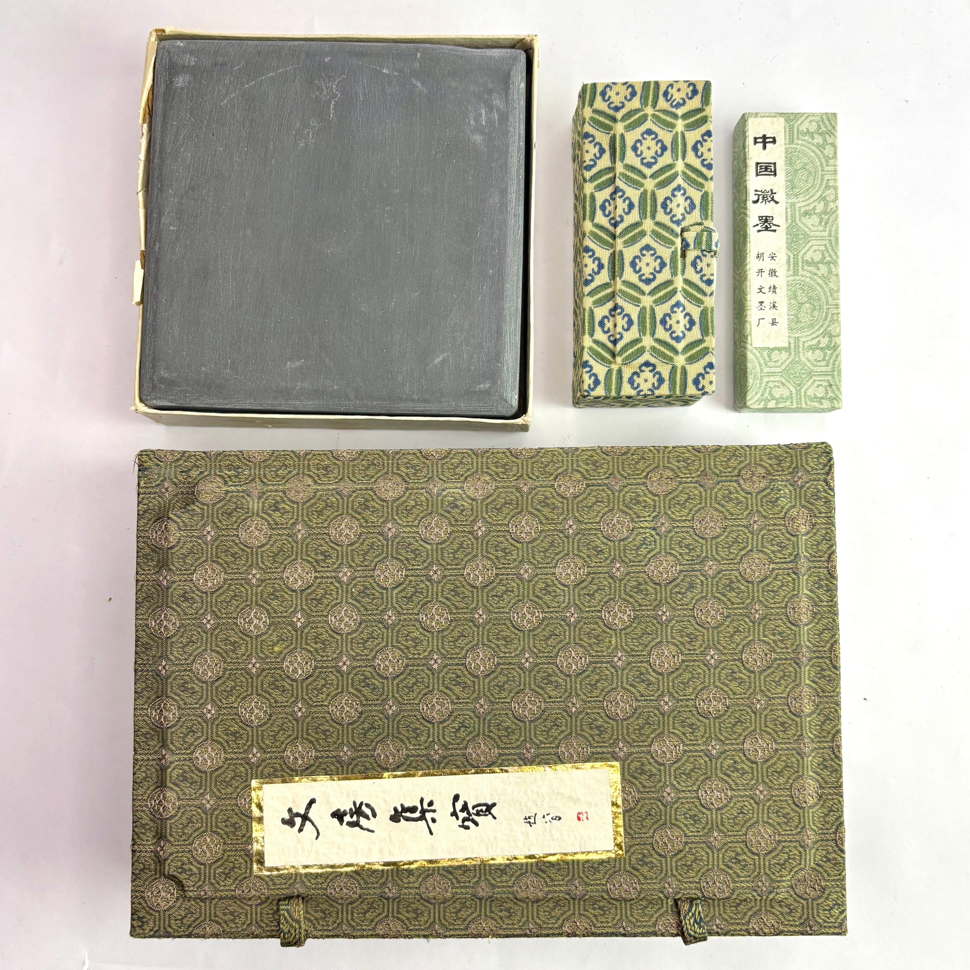 Set of traditional Chinese books and a stone on a white background