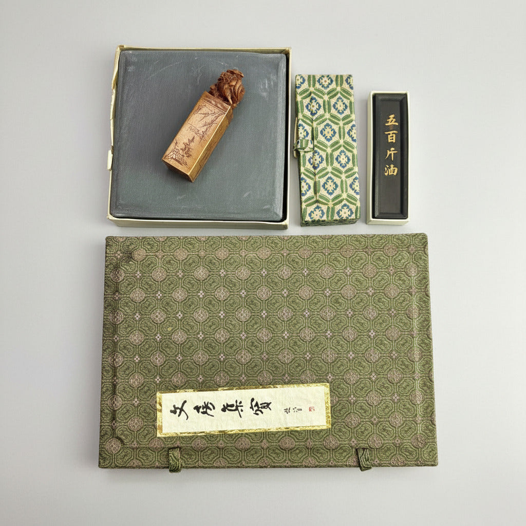 Traditional Chinese inkstone set with ink stick and ink stone on a white background