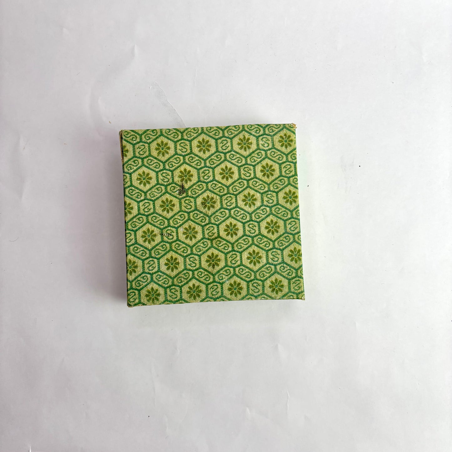 Green patterned box on a white background