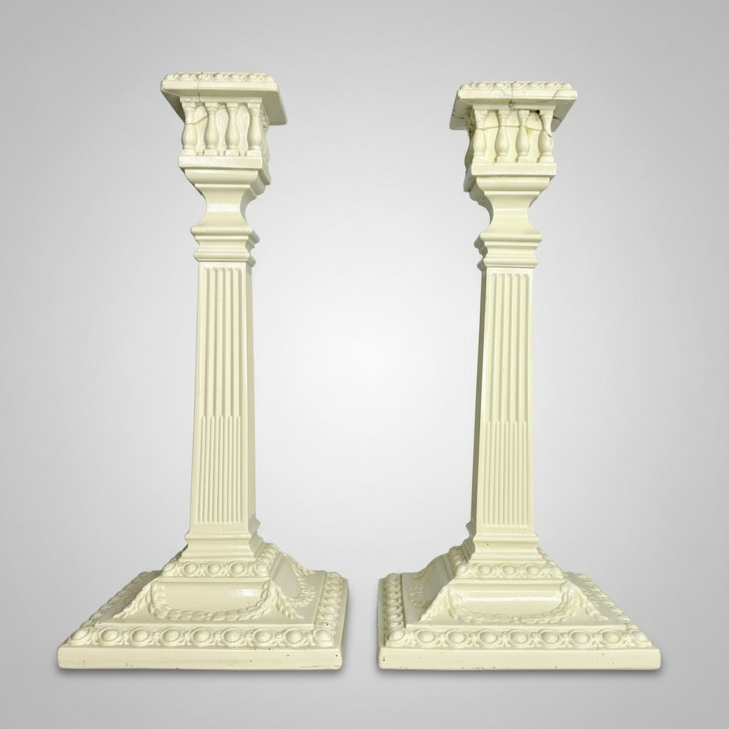 Two decorative white columns on a gray background