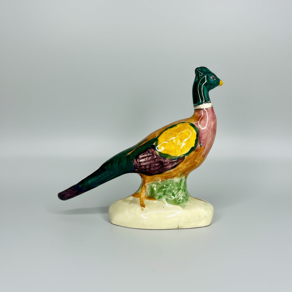 Colorful ceramic pheasant figurine on a white background
