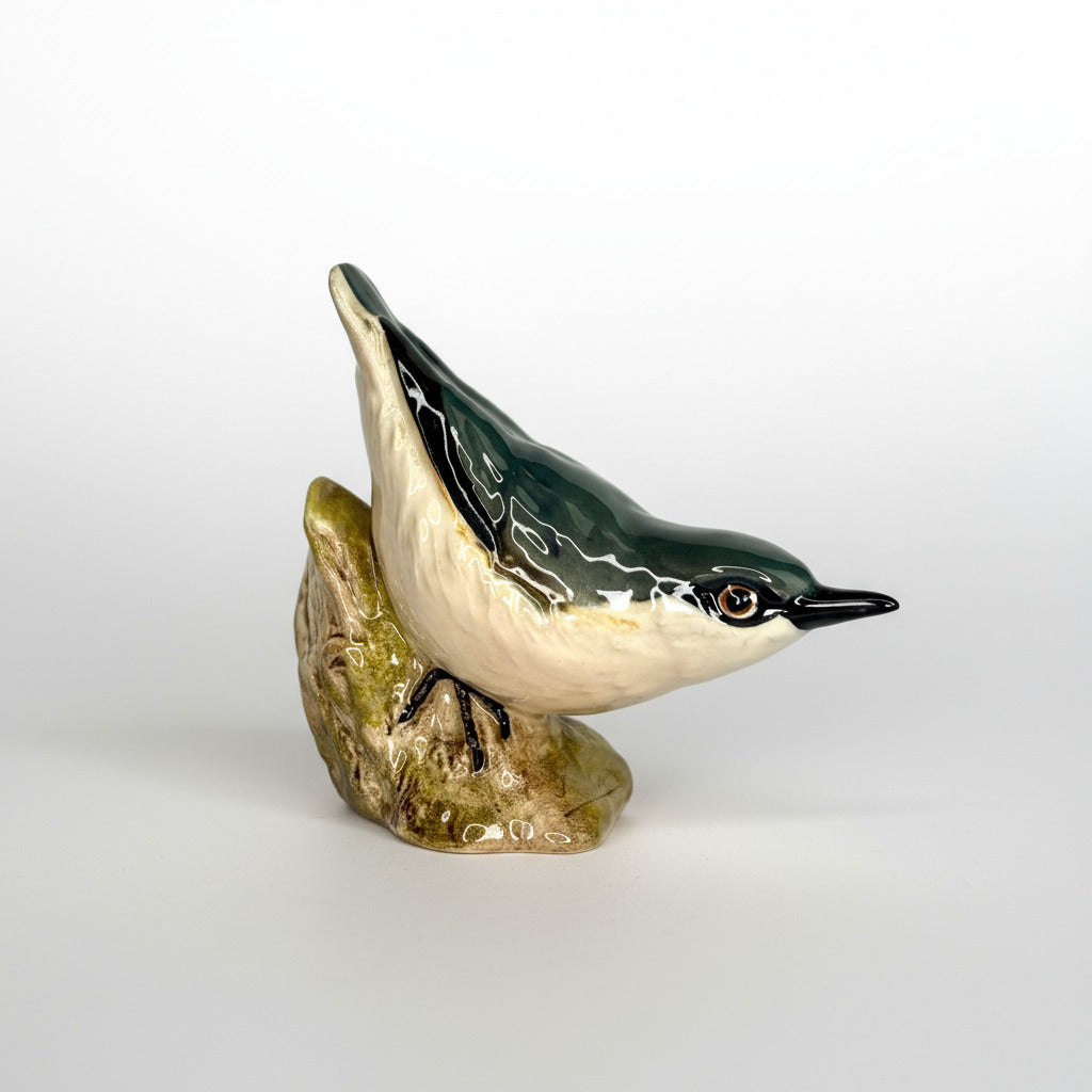 Ceramic bird figurine on a white background