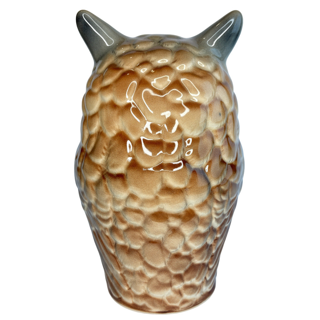 Ceramic owl figurine with textured brown body and gray horns on a light blue background