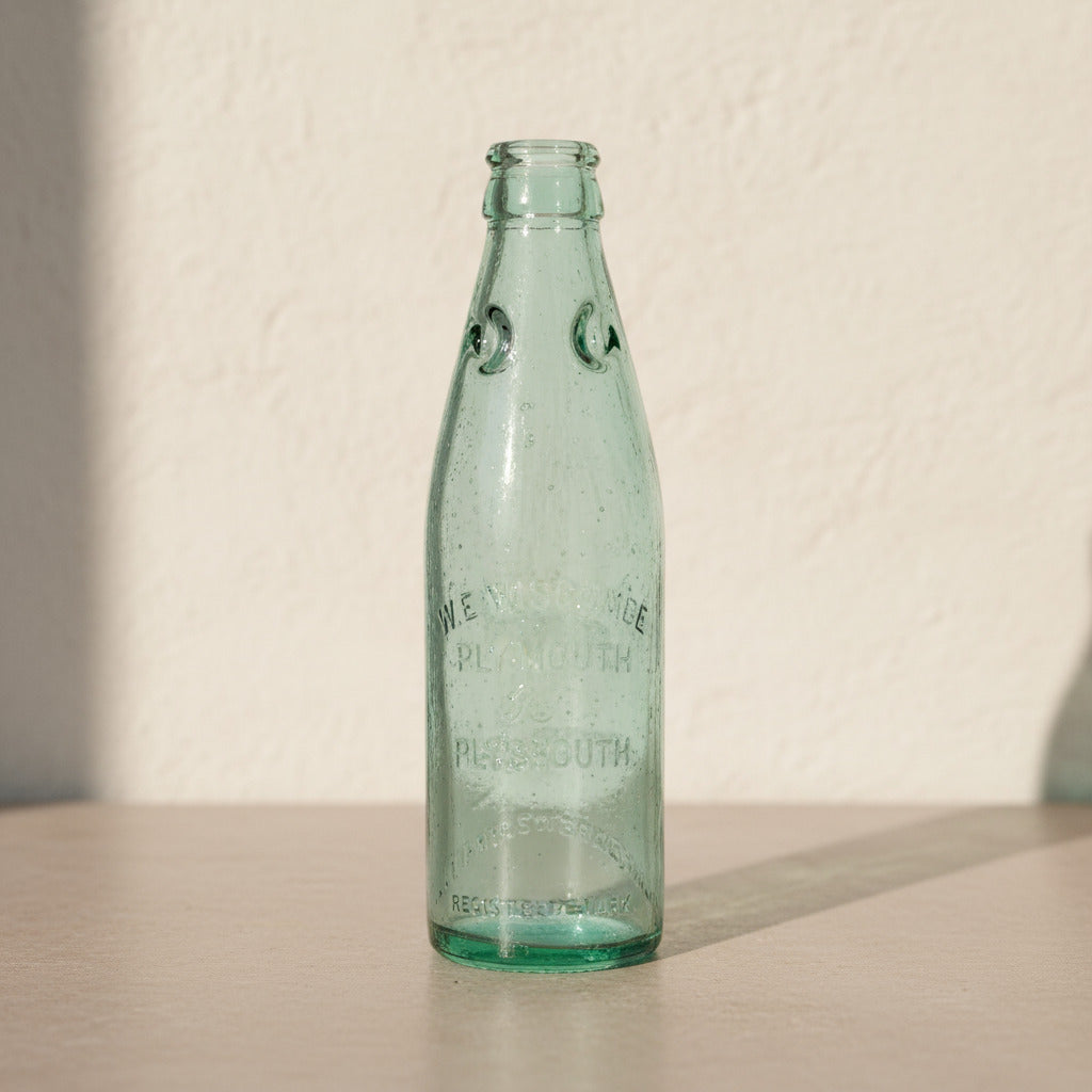 Green glass bottle on a white background