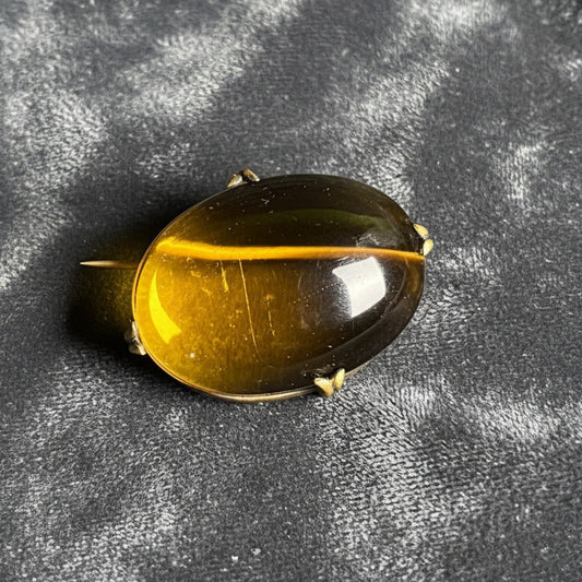 Black and yellow oval-shaped object on a gray surface