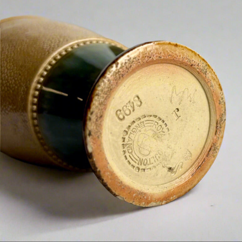 Close-up of a cylindrical object with a textured surface and visible branding on a gray background