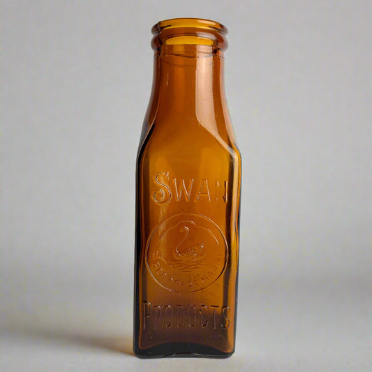 Brown bottle labeled 'Swan Products' on a white background