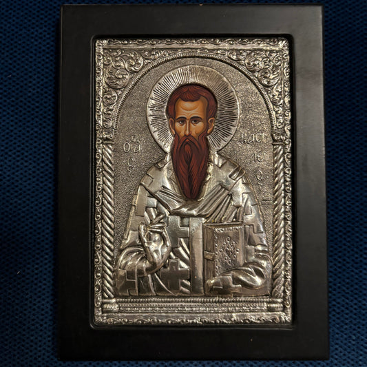 Decorative metal icon with intricate designs on a dark blue background