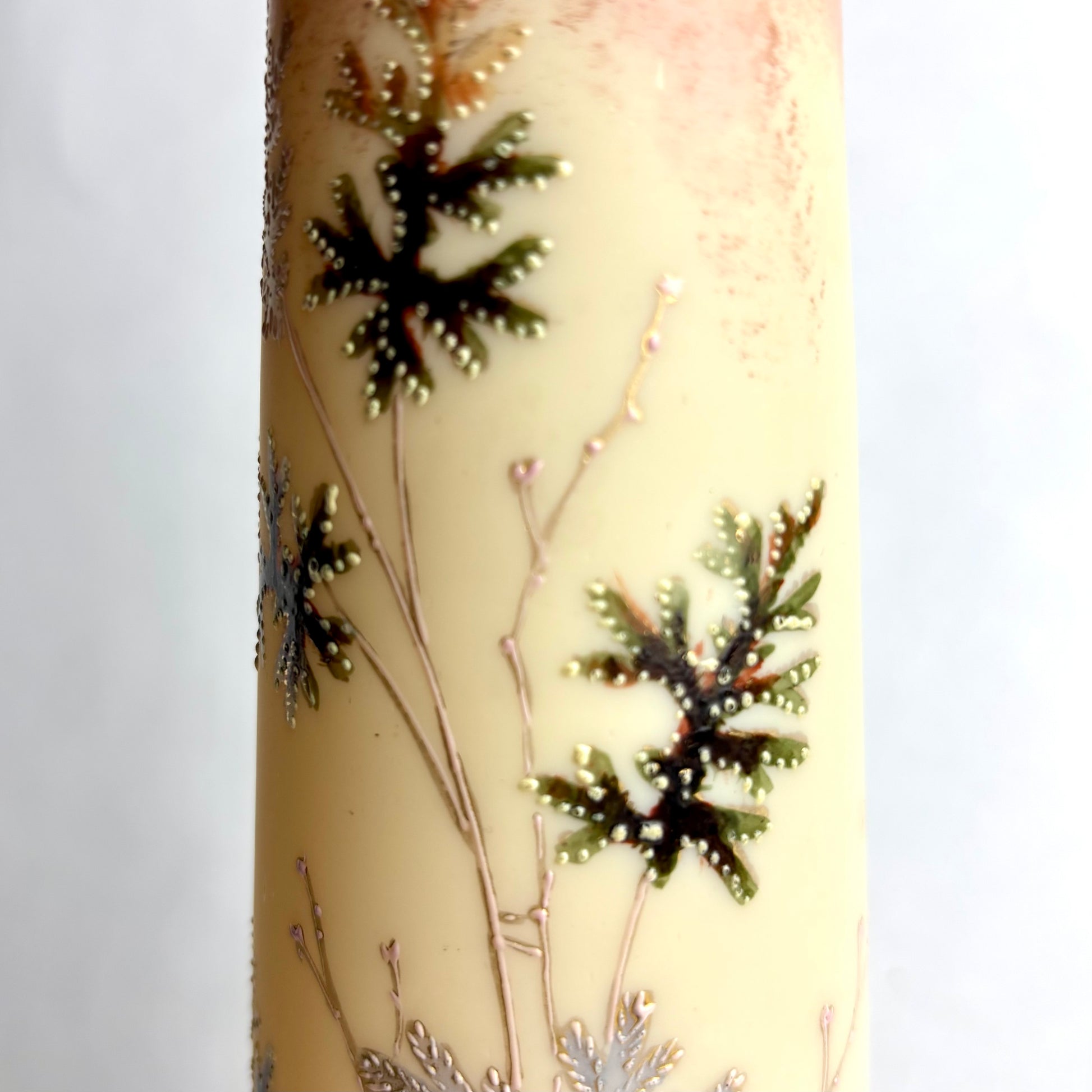 Decorative candle with black snowflake designs on a light background