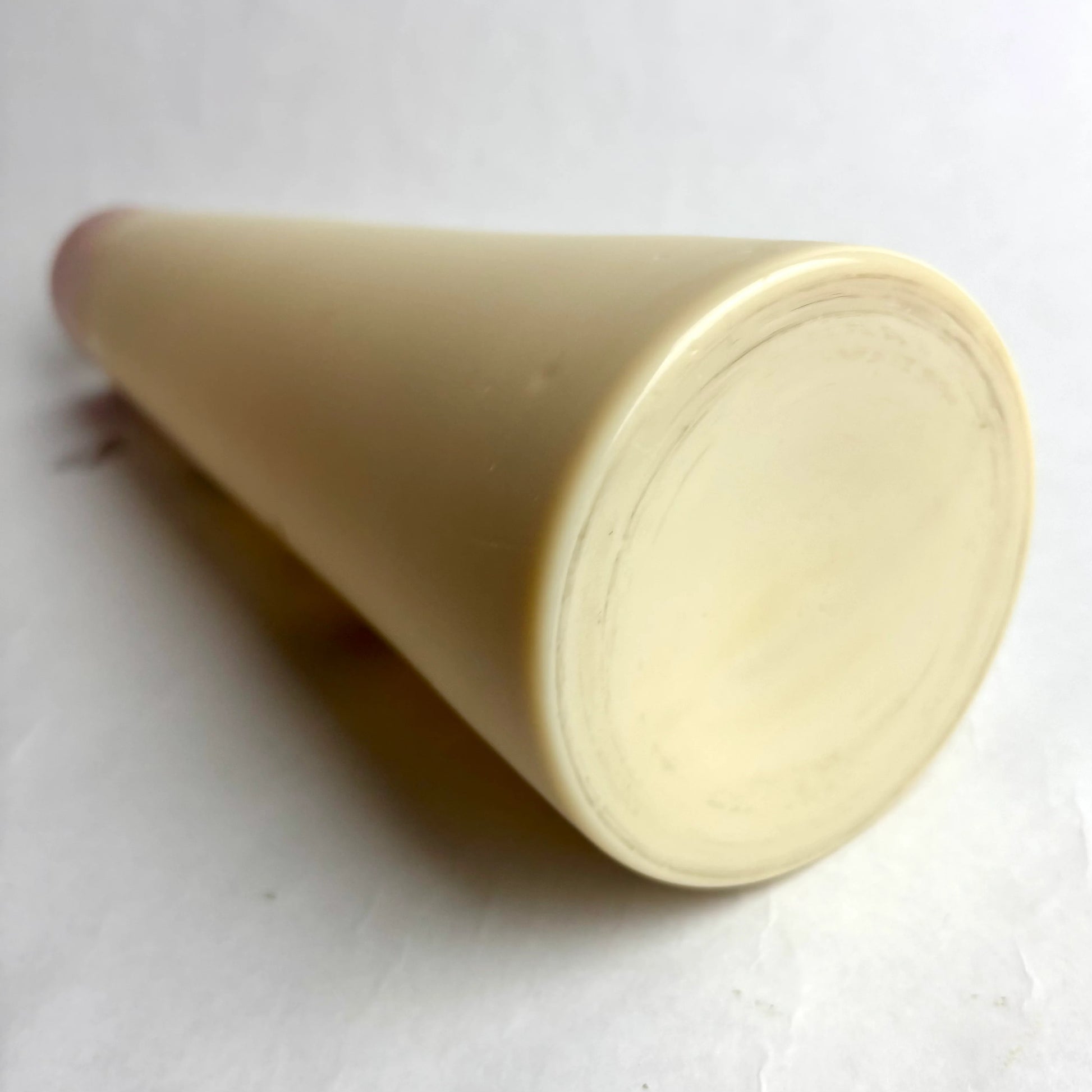 Beige cylindrical object on a white background