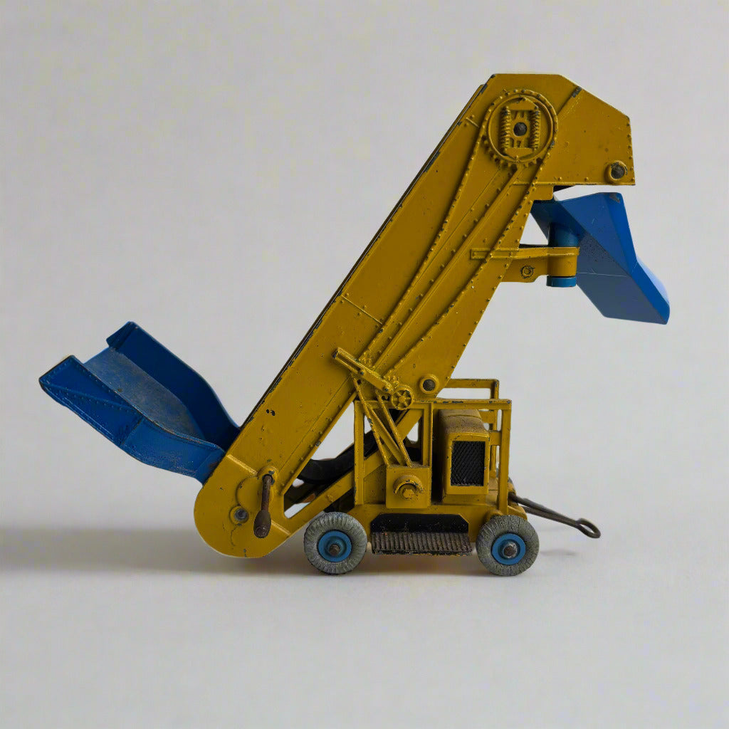 Yellow toy crane with blue attachments on a gray background