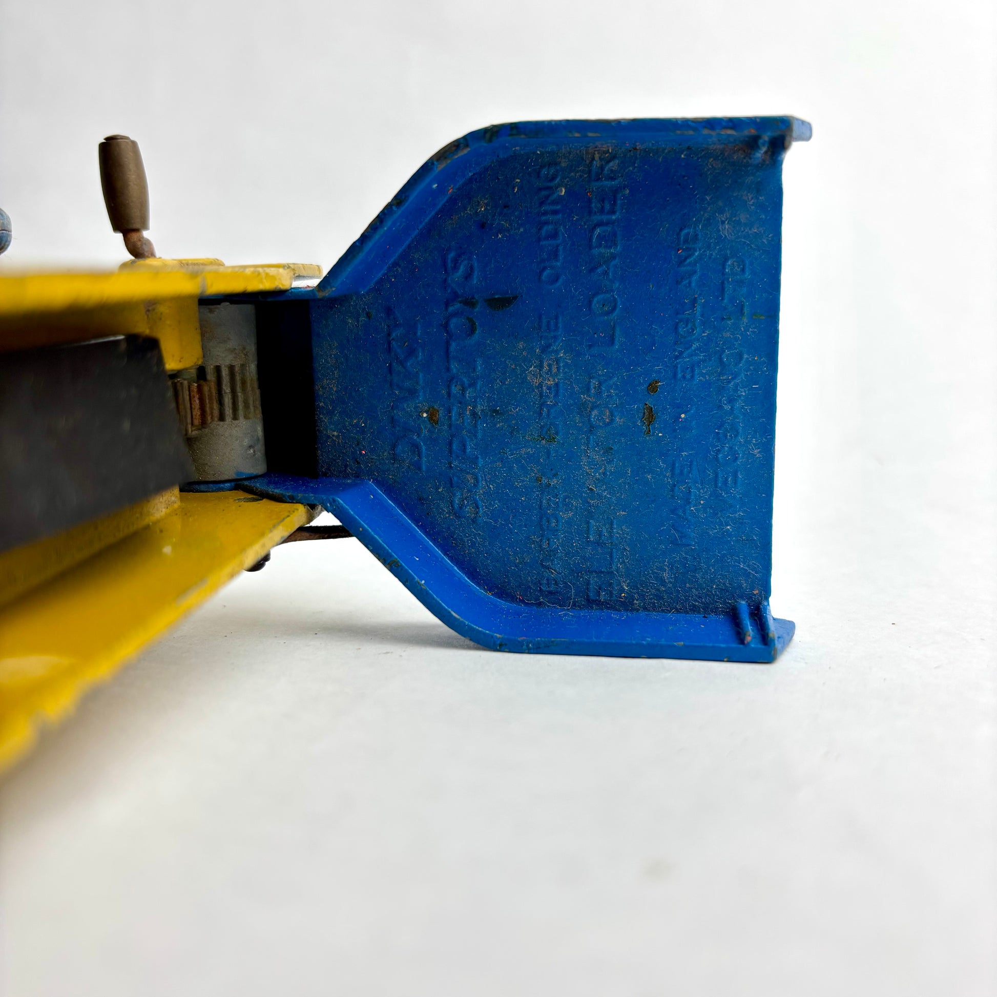 Close-up of a blue metal tool on a white background