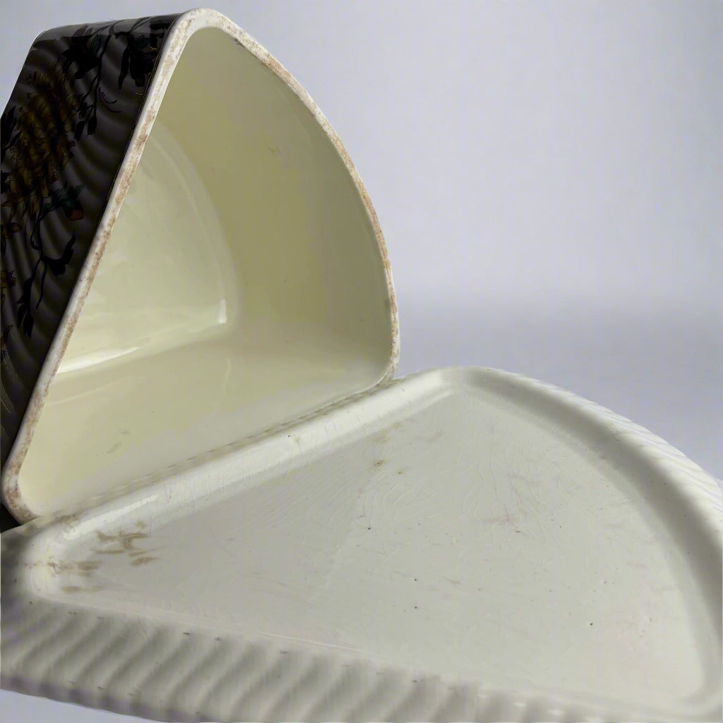 Close-up of a ceramic dish with a textured surface on a plain background