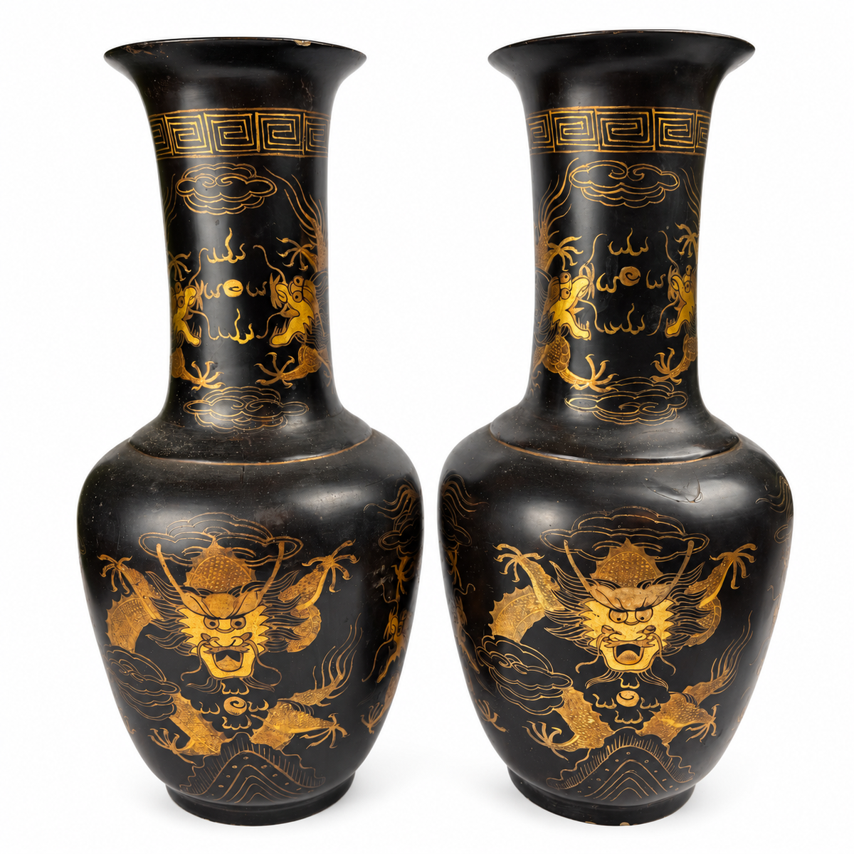 Pair of black and gold dragon vases on white background