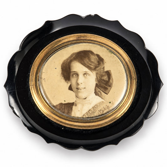 Late Victorian black mourning brooch with photographic portrait and gold coloured mount
