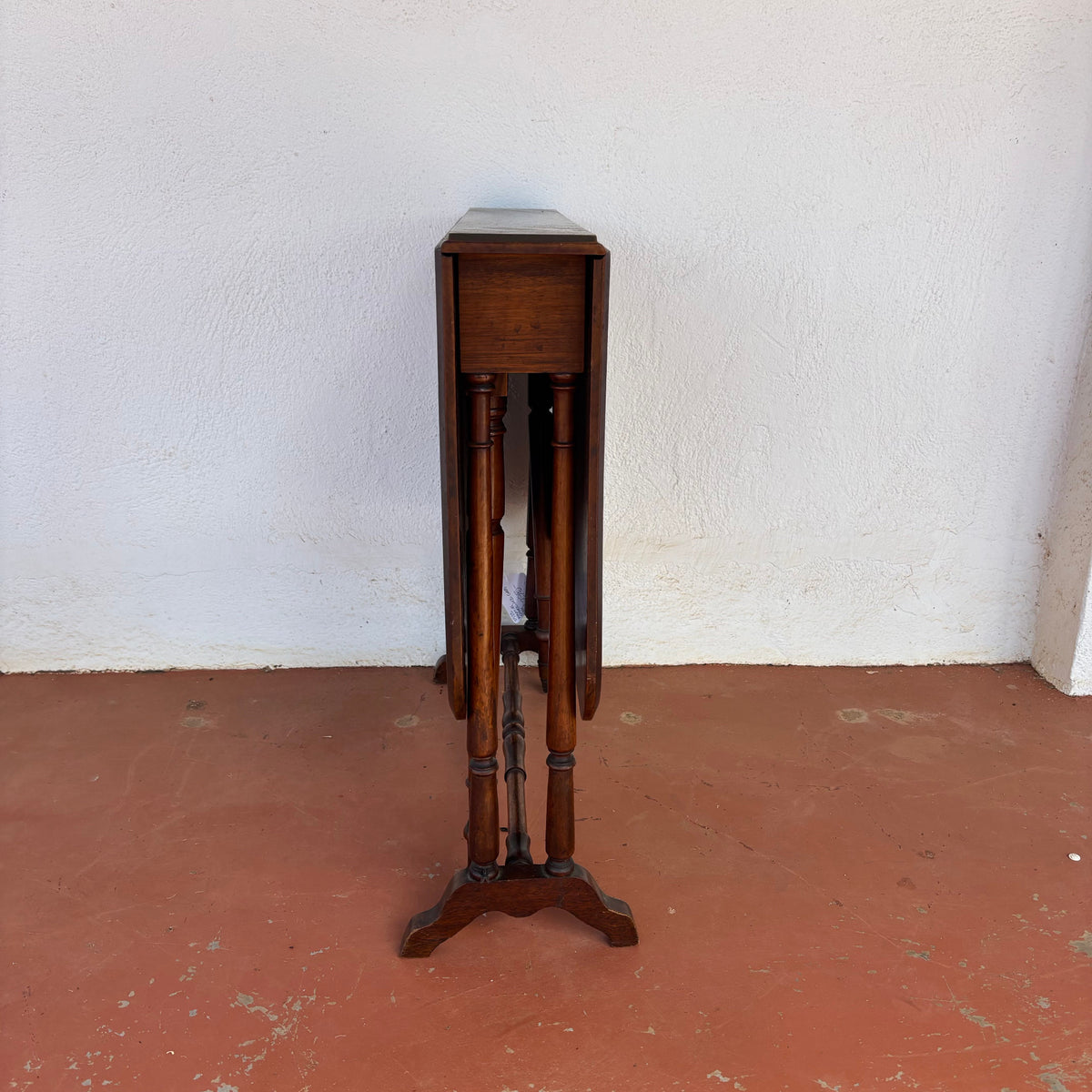 Antique timber drop-leaf table shown folded