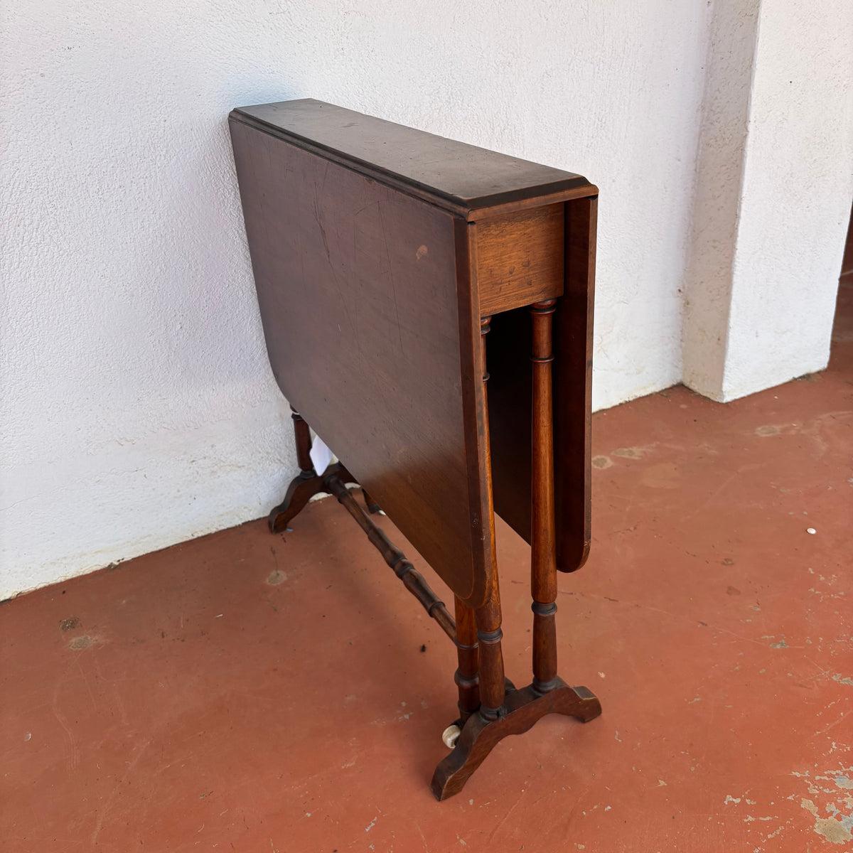 Antique timber drop-leaf table shown folded