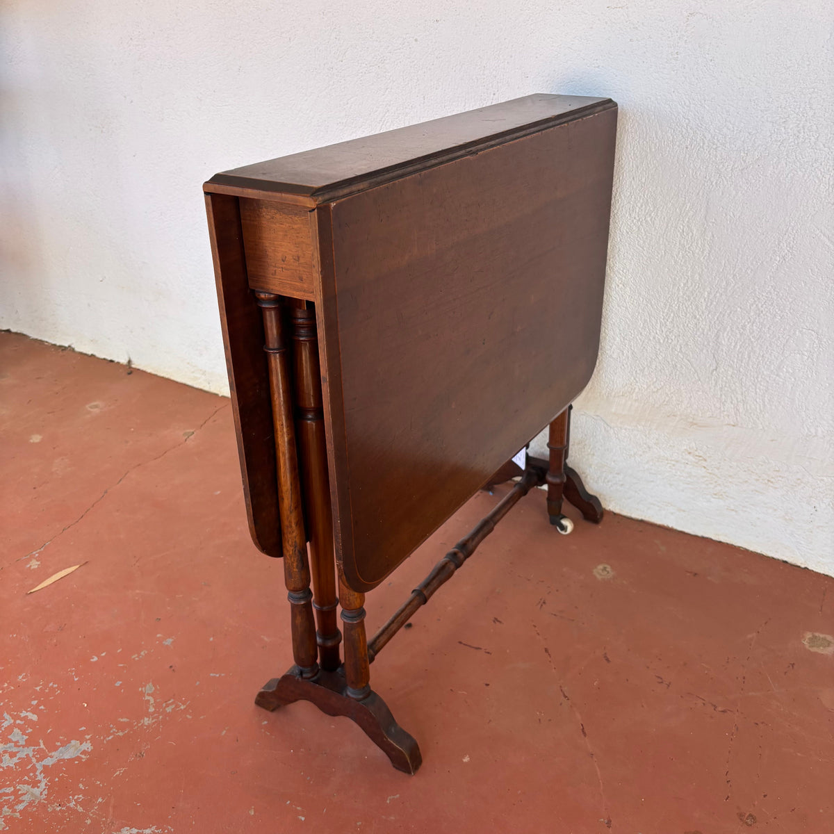 Antique timber drop-leaf table shown folded